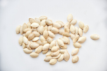 Pumpkin seeds on a white background close-up