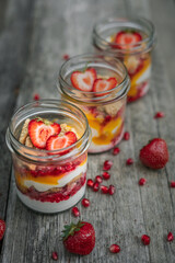 Plant based yogurt in a glass jar. Mango strawberry pudding. Vegan dessert.