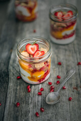 Plant based yogurt in a glass jar. Mango strawberry pudding. Vegan dessert.