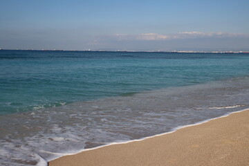 Fototapeta na wymiar Beautiful seascape photo. Warm day in the beach. Calm blue water, clear sky, no people. 