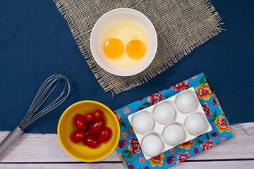 Eggs and little red tomatoes, recipe from top view