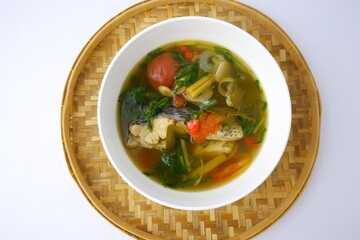 Boiled tilapia in white bowl on bamboo isolated on white background.
