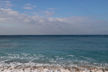 Fototapeta na wymiar Beautiful seascape photo. Warm day in the beach. Calm blue water, clear sky, no people. 
