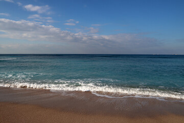 Beautiful seascape photo. Warm day in the beach. Calm blue water, clear sky, no people. 