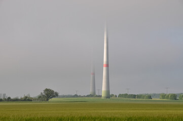 Fototapeta na wymiar wind turbine disappearing in fog