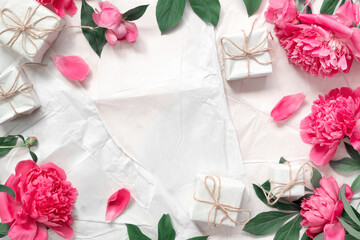 Beautiful delicate pink peonies on the background of vintage wrapping paper. Minimal concept...