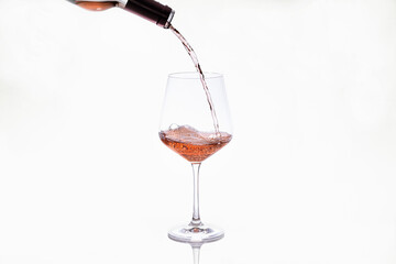 Glass getting wine poured from a bottle