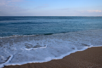 Clear blue sea water close up photo. Calm sea, blue sky,  tranquil scene. Warm day on the beach. 