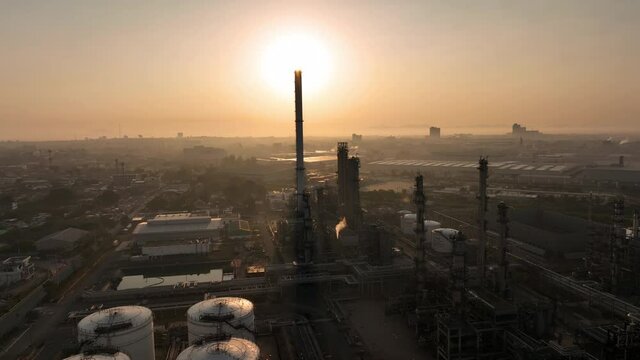 Sunset on chimey pipe Chemical oil refinery plant, power plant and metal pipe concept industry