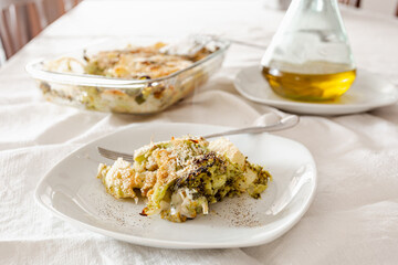 Broccoli, potato and vegan cheese pie on a white plate