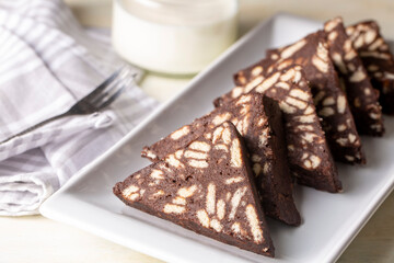 Delicious mosaic chocolate and biscuit cake served in a white plate (Turkish name; Mozaik pasta or Mozaik kek)