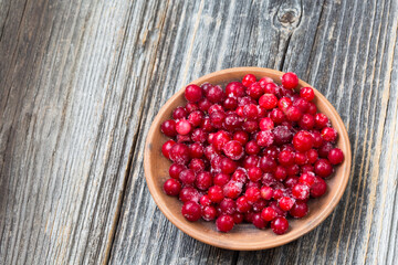 Scandinavian style background with wooden desk and lingonberries. copy space, top view.Vegetarian organic food