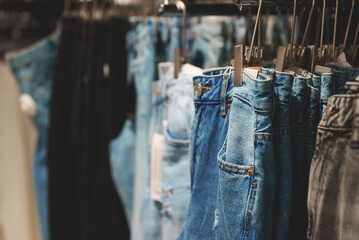 Rack with jeans in clothing store.