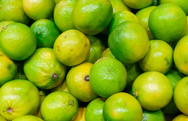 Close-up view of organic limes in the basket.