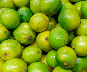 Close-up view of organic limes in the basket.