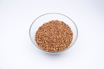 Buckwheat in glass bowl isolated on white background