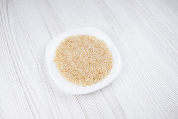 rice in a white plate on the table 