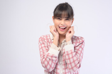 Young smiling woman holding invisalign braces over white background studio, dental healthcare and Orthodontic concept.