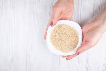 female hands plate with rice