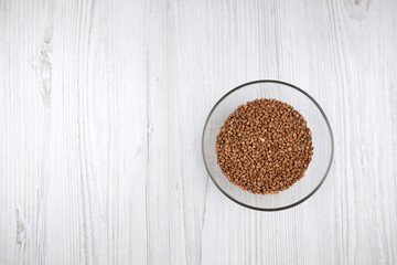 Buckwheat in a transparent bowl on the table free space