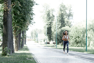 Fototapeta na wymiar Latina afro beautiful woman runner. She was running on the road in the morning.