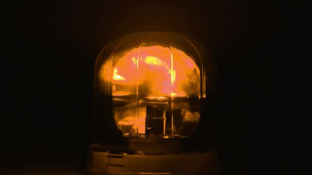 Warning alarm siren rotating and blinking at dark