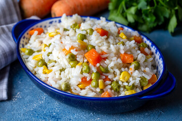 Delicious vegetable rice pilaf with green peas, carrots and sweet corn (Turkish name; sebzeli pilav)