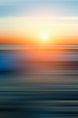 Blurred background of the sunset sky over the sea. Vertical photography.