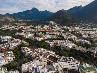 Fototapeta na wymiar Aerial view of Barra da Tijuca, Rio de Janeiro, Brazil. Big hills around like Pedra da Gávea. Sunny day with some clouds at dawn. Drone Photo