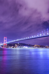Vertical shoot of 15 July Martyrs Bridge (15 Temmuz Sehitler Koprusu) Violet, purple cloudy sky and sea in Istanbul, Turkey. Istanbul Bosphorus Bridge, Panorama, long exposure.