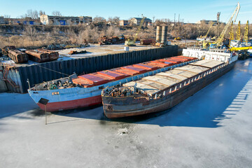 Cargo transportation. Old cargo ship. Winter layup of ships at the mouth of the Volga River in...