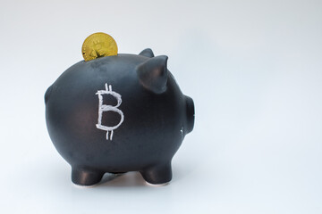 a bitcoin coin is stuck in a piggy bank