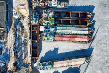 Fototapeta na wymiar View from above. Winter layup of ships at the mouth of the Volga River in Volgograd. Russia. Cargo transportation. many ships.