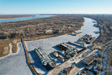 View from above. Winter layup of ships at the mouth of the Volga River in Volgograd. Russia. Cargo...