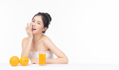 Obraz na płótnie Canvas Happy young woman laughing Orange juice and orange on a table with isolated on white background and copy space Beauty asian girl love eating fruit and orange juice Health care and beauty skin concept