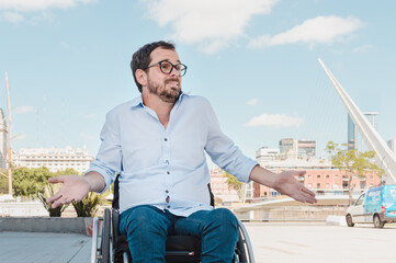 adult man outdoors sitting in wheelchair with frown and i don't care expression