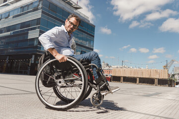 adult latin caucasian man outdoors in wheelchair doing wheelie