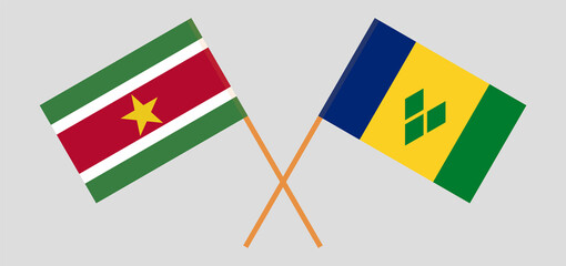 Crossed flags of Suriname and Saint Vincent and the Grenadines. Official colors. Correct proportion