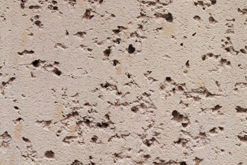 Texture of rough porous plaster of pink color 