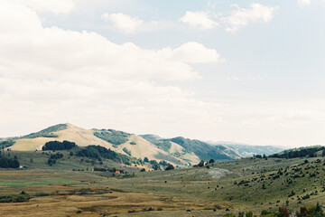 Green hills against a cloudy sky