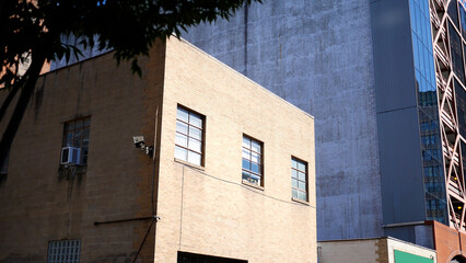 Fototapeta premium A Small Old Industrial Building with Tan Bricks In City Area