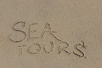 Season of travel. sea tour. Summer trips to the sea. Concept of leisure and travel. inscription sea on the wet sand of the coast