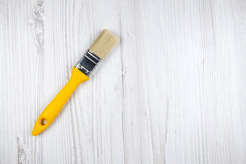 Paint brush on the table, free space.  Top view of small paint brush, minimalistic style