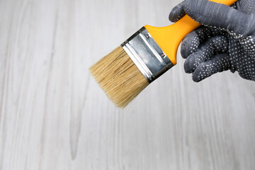 Big clean paint brush in hand. Tools for repair
