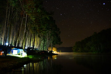 Beautiful night with starry sky and river shore landscape. Beautiful landscapes of a lake in the mountains	