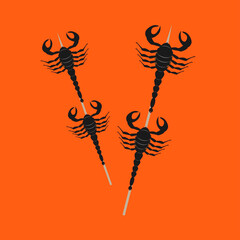 edible fried insects scorpion on a stick and plates with lettuce leaves