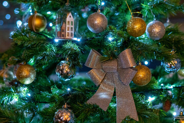 A close up shot of multiple christmas decoration hanging on the tree