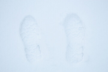Footprints of boots in the snow.
