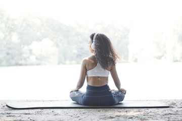 Young girl meditating in the park. Happiness joy and healthy lifestyle concept