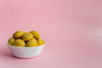 Oatmeal cookies on a white plate on a pink background with space for text on the right. Healthy food concept. High-quality photo